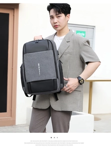 Business laptop backpack with USB port and gray-black textured fabric on male model