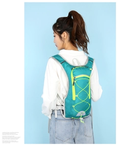 Detail view of lightweight cycling backpack with lime green fabric and neon cords