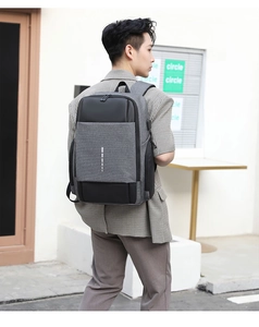 Detail of grey business laptop backpack featuring external USB charging port and sleek design