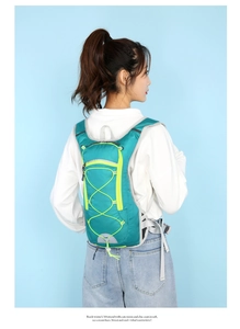 Rear view of turquoise cycling backpack with breathable mesh and reflective gray strips
