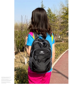 Detailed close-up of water-resistant honeycomb texture on black outdoor backpack