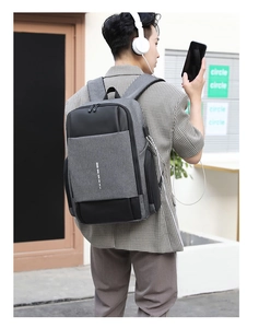 Men's laptop backpack with USB charging port showing side view and reflective strip