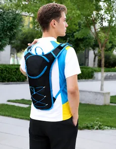 Outdoor cycling backpack with bungee cords shown on model in a green park