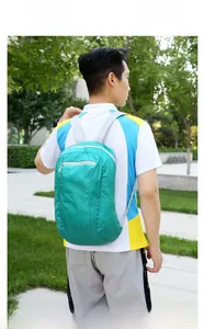 Outdoor foldable emerald green backpack shown on a person for daily travel and hiking