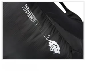 Close-up of black ripstop fabric texture and white VANAHEIMR logo on outdoor backpack
