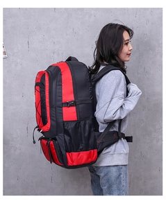 Detail of red and black outdoor hiking backpack featuring multiple zipper compartments
