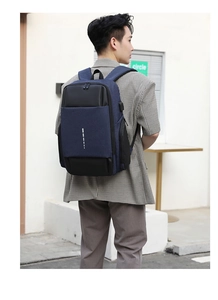 Close-up of padded shoulder straps and USB charging port on navy business backpack