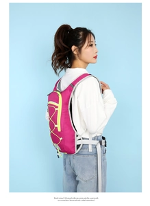 Detail of a pink cycling backpack showing adjustable side buckles and durable nylon fabric