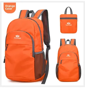 Macro detail of foldable orange nylon backpack with mesh side pocket and grey accents