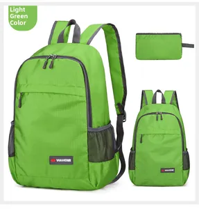 Macro detail of foldable light green backpack featuring ripstop texture and storage pouch