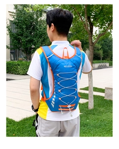 Detail of 12L hydration backpack with orange elastic cords and silver reflective strips