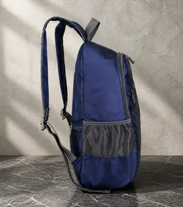 Side view of dark blue lightweight foldable backpack with grey mesh side pocket