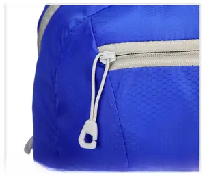 Close-up of blue honeycomb ripstop fabric with smooth grey zipper and long puller
