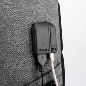 Men's laptop backpack with USB charging port and headphone jack on gray fabric