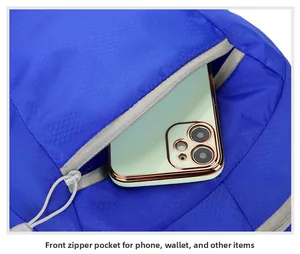 Detail of blue foldable backpack with waterproof honeycomb texture and front zipper pocket