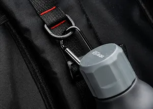 Close-up of black tactical backpack nylon webbing with D-ring and carabiner for water bottles