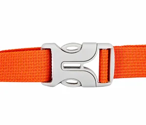 Close-up of durable orange strap and gray plastic buckle on cycling backpack