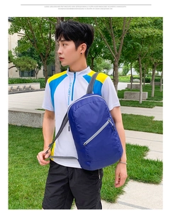 Close-up of lightweight blue hiking backpack showing waterproof fabric and breathable mesh