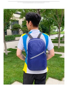 Detail of navy blue packable backpack with breathable mesh straps for outdoor travel