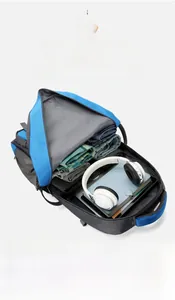 Detail view of large capacity blue backpack interior with laptop and travel essentials
