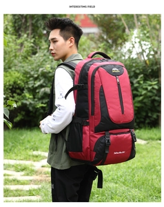 85L large capacity red and black hiking backpack worn by a male hiker in a park setting