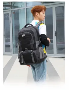 Detail of a large black hiking backpack with multi-pocket design and ergonomic straps
