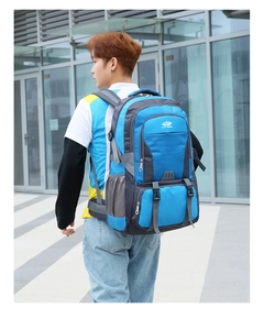 Blue and grey hiking backpack with reinforced shoulder straps and side mesh pocket