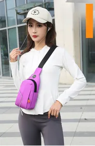 Detail of purple waterproof chest bag showing front zip pocket and headphone port