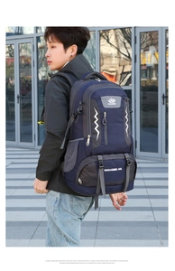 Side view of man carrying large 60L blue hiking backpack with nylon texture and straps