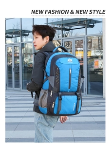 Side view of an 80L blue outdoor hiking backpack worn by a male model in daylight
