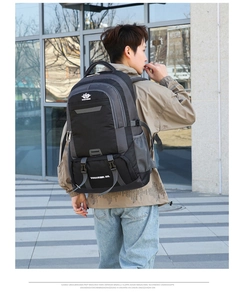 Close-up of a large black waterproof hiking backpack with gray side mesh water bottle pocket