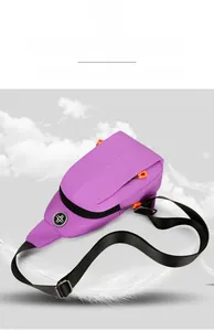 Detail of purple oxford chest bag with lightweight design and orange zipper accents