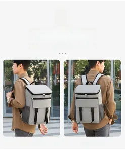 Gray insulated backpack showing versatile shoulder and dual-strap carrying modes outdoors