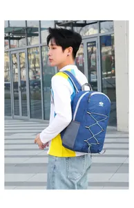 Detail of navy blue foldable backpack with white elastic cord and mesh side pocket