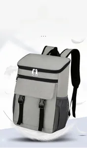 Detail of grey insulated backpack showing side mesh pocket and buckle flap on durable fabric