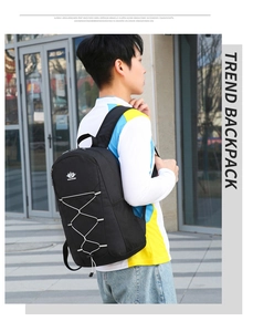 Side view of male model wearing a black foldable travel backpack with elastic front cords
