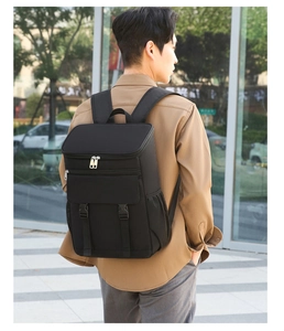 Outdoor view of a black insulated backpack showing its side mesh pockets and buckle straps