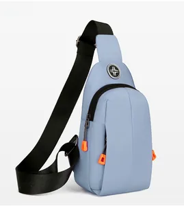 Detailed side view of water-resistant blue nylon sling bag with orange zipper pull detail