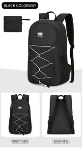 Detail view of foldable black travel backpack with white elastic cords and storage pouch