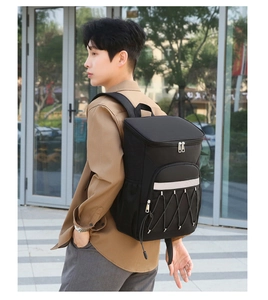 Outdoor lifestyle view of a black insulated picnic backpack with elastic storage cords