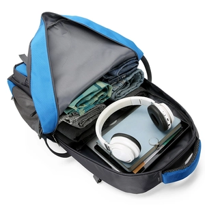 Large capacity blue hiking backpack showing spacious interior with clothes and laptop