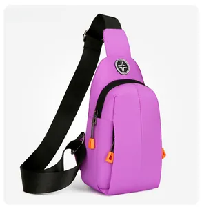 Angle view of purple oxford fabric chest bag with orange zipper pull and black strap