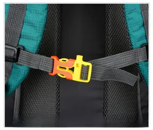 Detail of teal hiking backpack featuring orange chest buckle and breathable black mesh straps