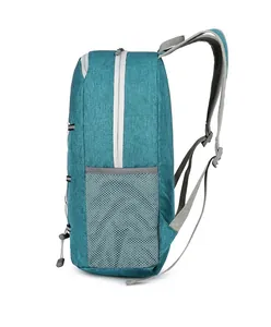 Side view of foldable teal outdoor backpack showing grey mesh pocket and durable fabric texture