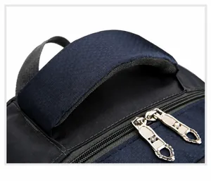 Close-up of padded top handle and durable dual metal zippers on blue hiking backpack