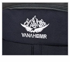 Close-up of VANAHEIMR brand logo embroidery with mountains and wings on outdoor backpack