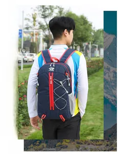 Outdoor foldable backpack in blue and red shown on a male hiker in a park setting