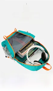 Internal view of a turquoise outdoor backpack showing large capacity storage for electronics