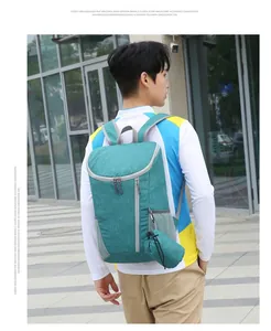 Outdoor traveler wearing water-resistant teal backpack with grey side mesh pocket