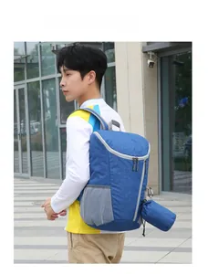 Side view of a grey-blue foldable waterproof backpack during outdoor hiking activities